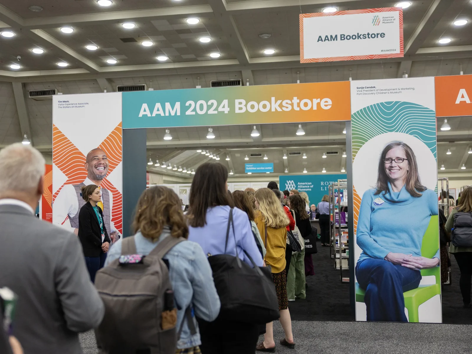 Attendees gathered at the AAM 2024 Bookstore conference booth featuring branded signage and display materials
